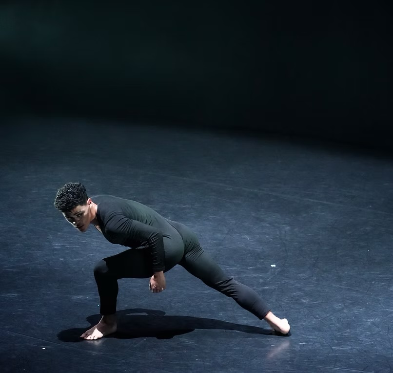 Black Beauty dancer performing a low lunge on stage